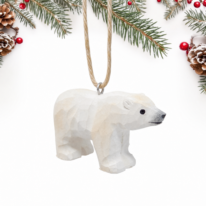 Polar Bear hand-carved wooden ornament by Selsela, on a plain background
