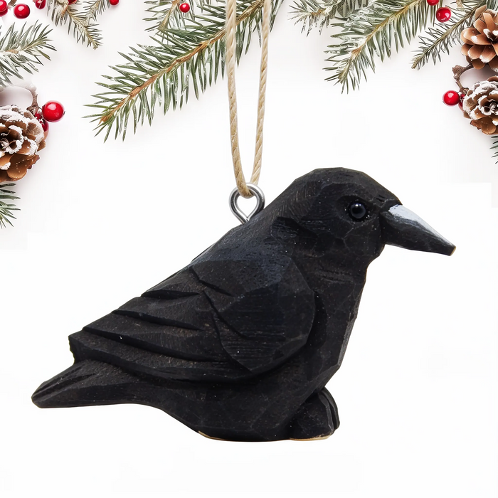 Raven hand-carved wooden ornament by Selsela, on a plain background