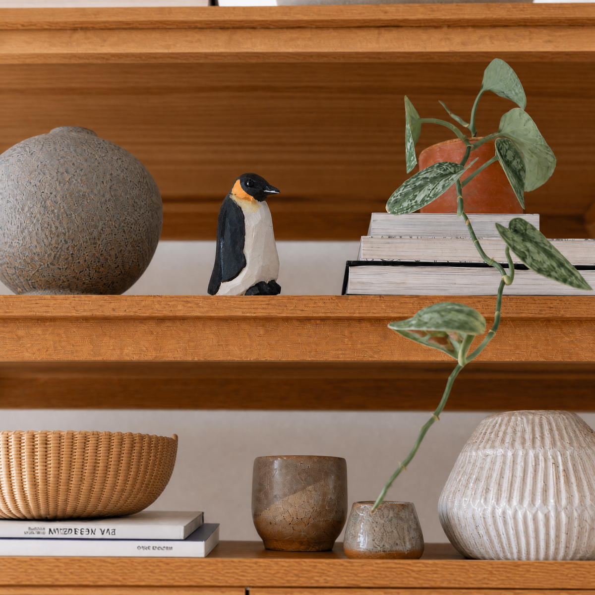 Penguin hand-carved wooden figurine by Selsela, styled in a home setting