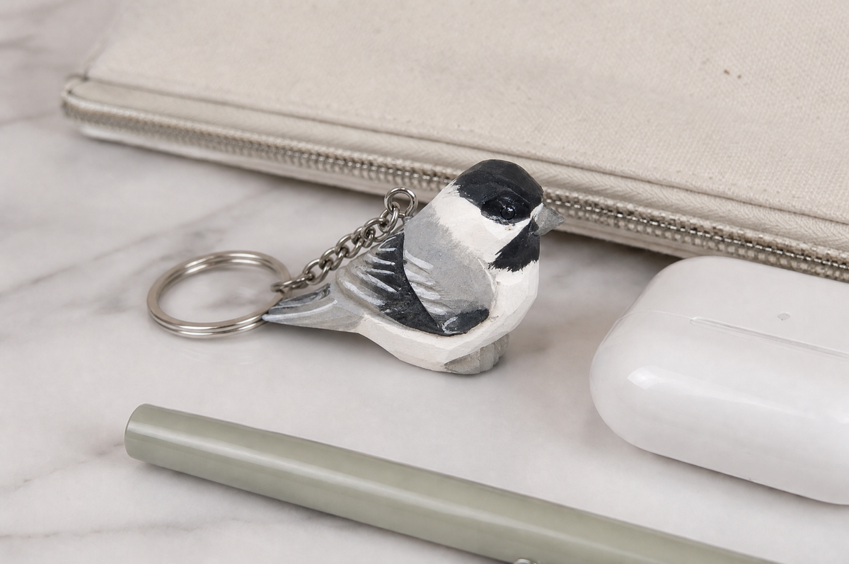 Chickadee hand-carved wooden keychain by Selsela, in a styled scene