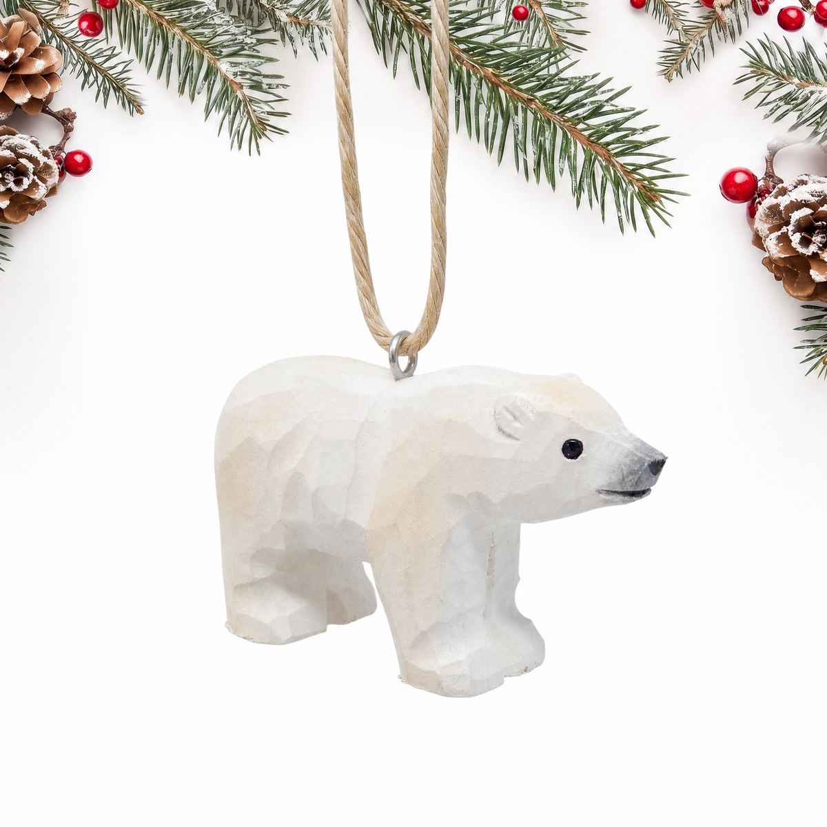 Polar Bear hand-carved wooden ornament by Selsela, on a plain background