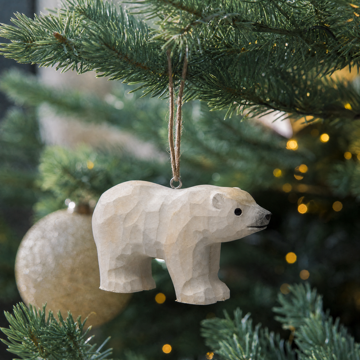 Polar Bear hand-carved wooden ornament by Selsela, hanging on a Christmas tree