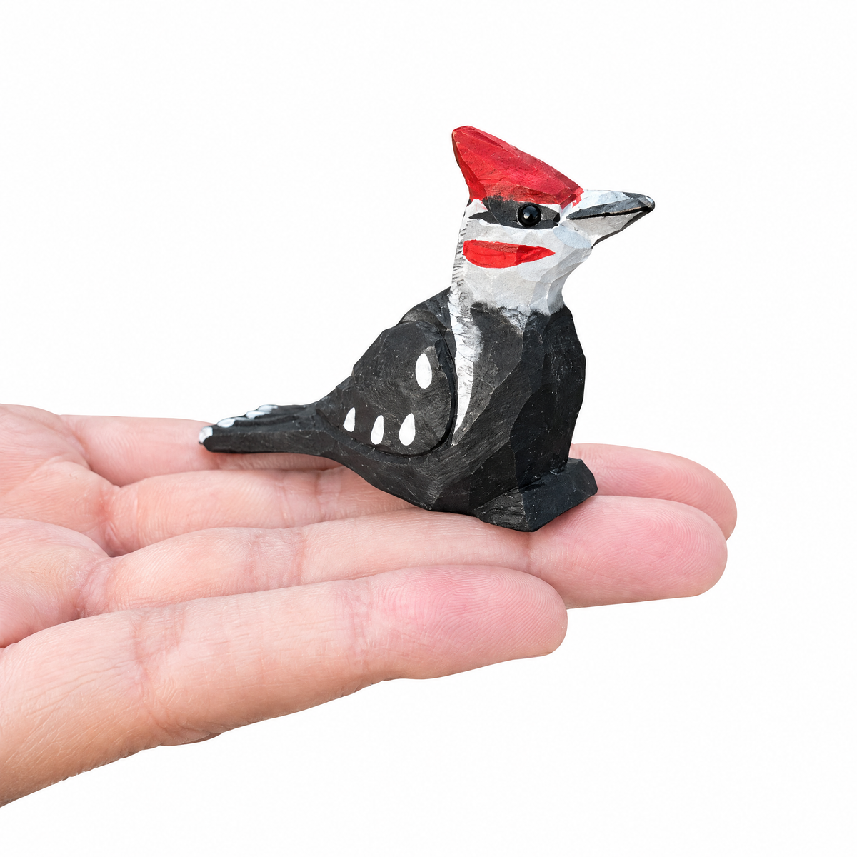 Pileated Woodpecker hand-carved wooden figurine by Selsela, on a plain background