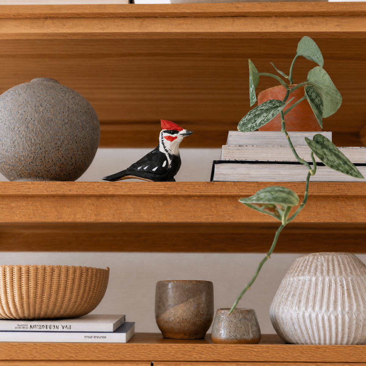 Pileated Woodpecker hand-carved wooden figurine by Selsela, styled in a home setting