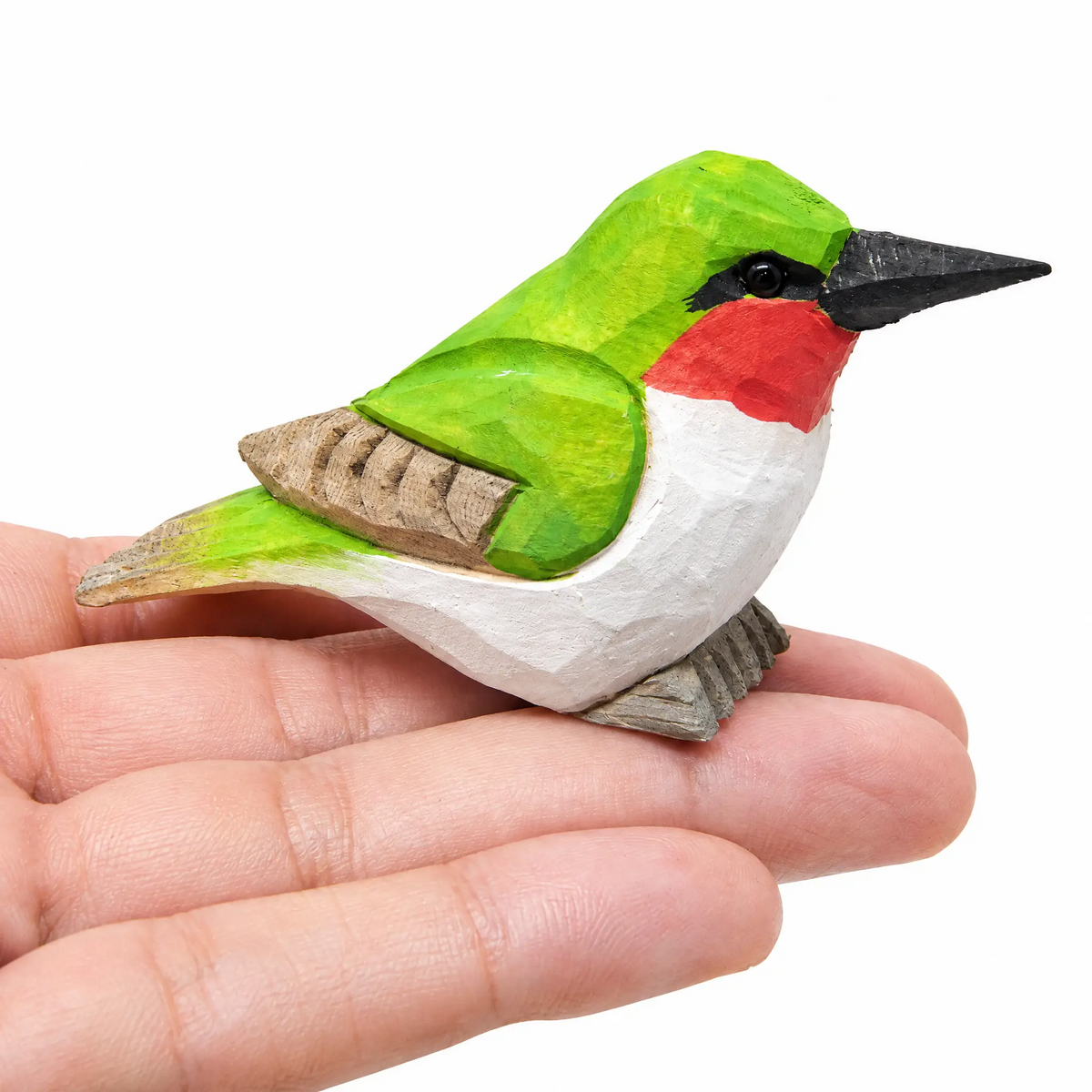 Hummingbird hand-carved wooden figurine by Selsela, on a plain background