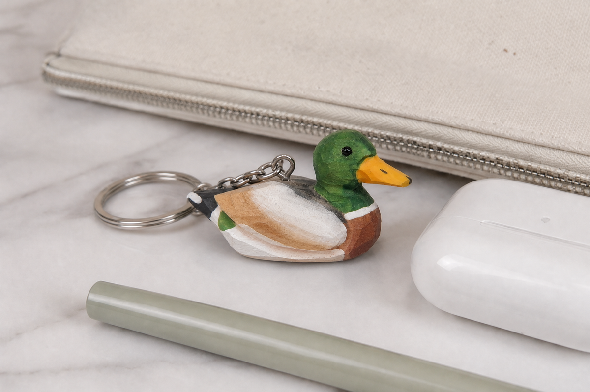 Mallard Duck Male hand-carved wooden keychain by Selsela, in a styled scene