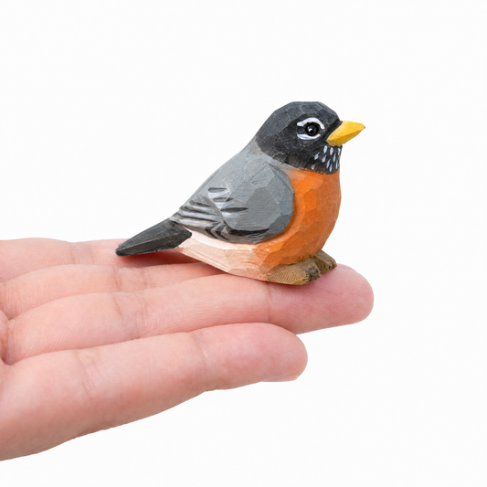 American Robin hand-carved wooden figurine by Selsela, on a plain background