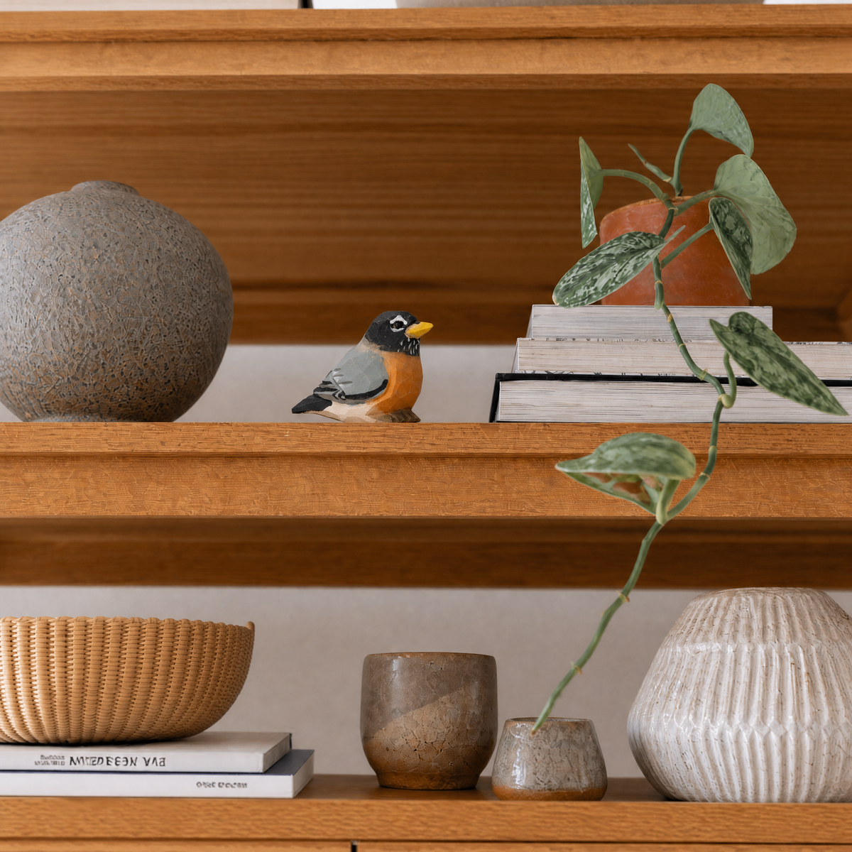 American Robin hand-carved wooden figurine by Selsela, styled in a home setting