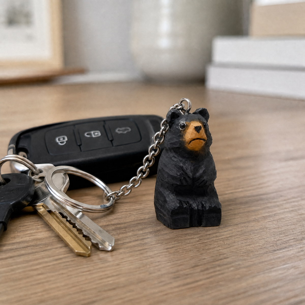 Black Bear hand-carved wooden keychain by Selsela, in a styled scene