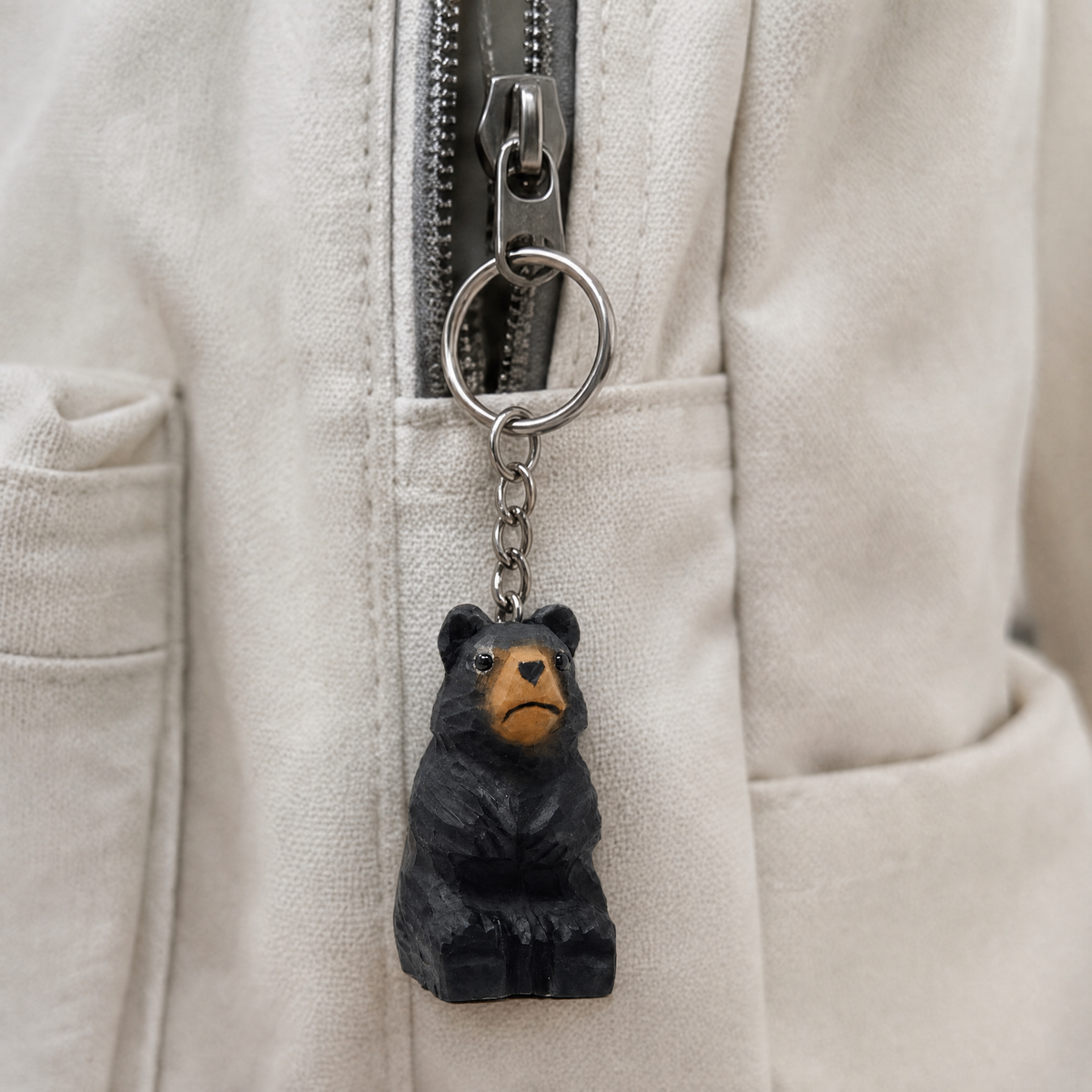 Black Bear hand-carved wooden keychain by Selsela, in a styled scene
