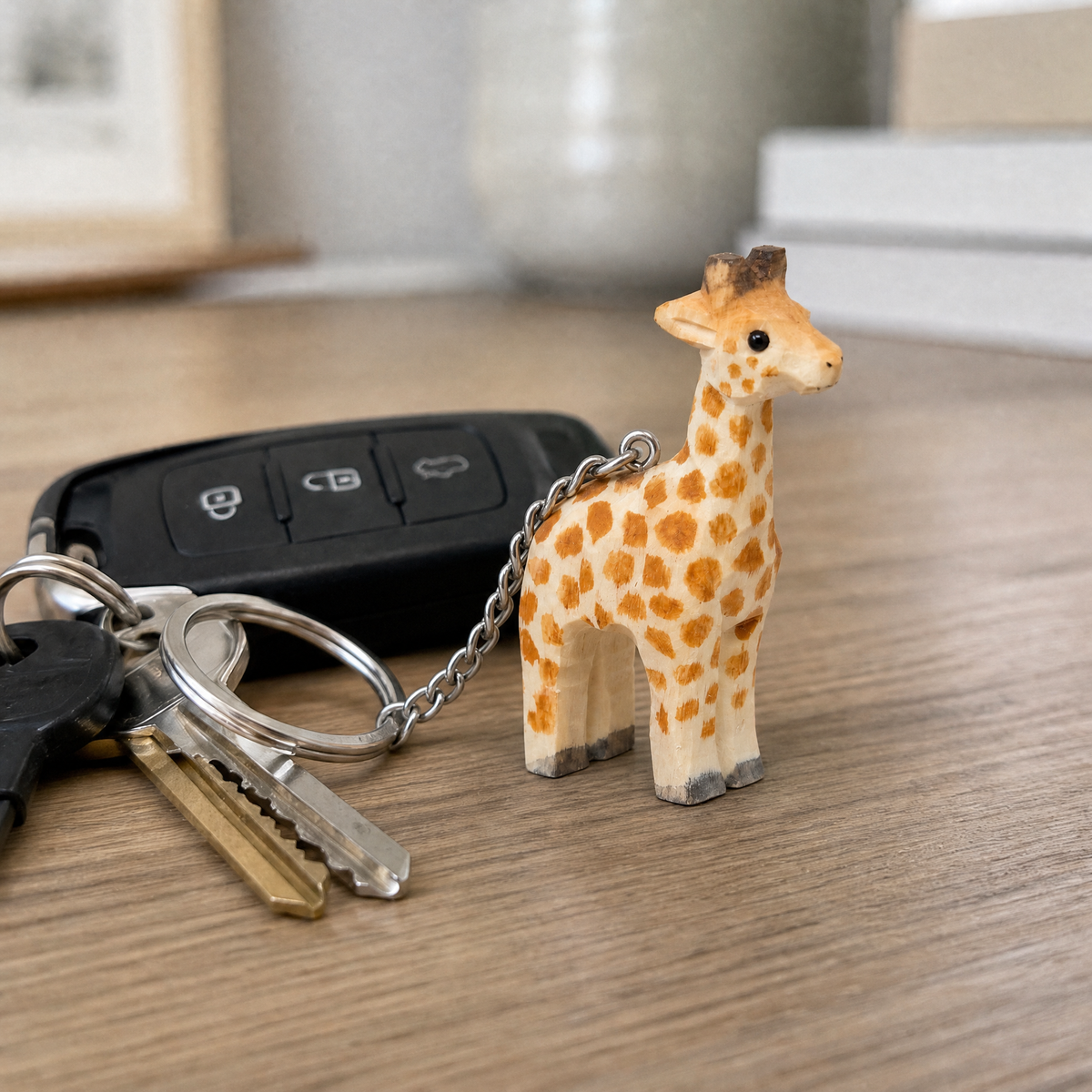 Giraffe hand-carved wooden keychain by Selsela, in a styled scene