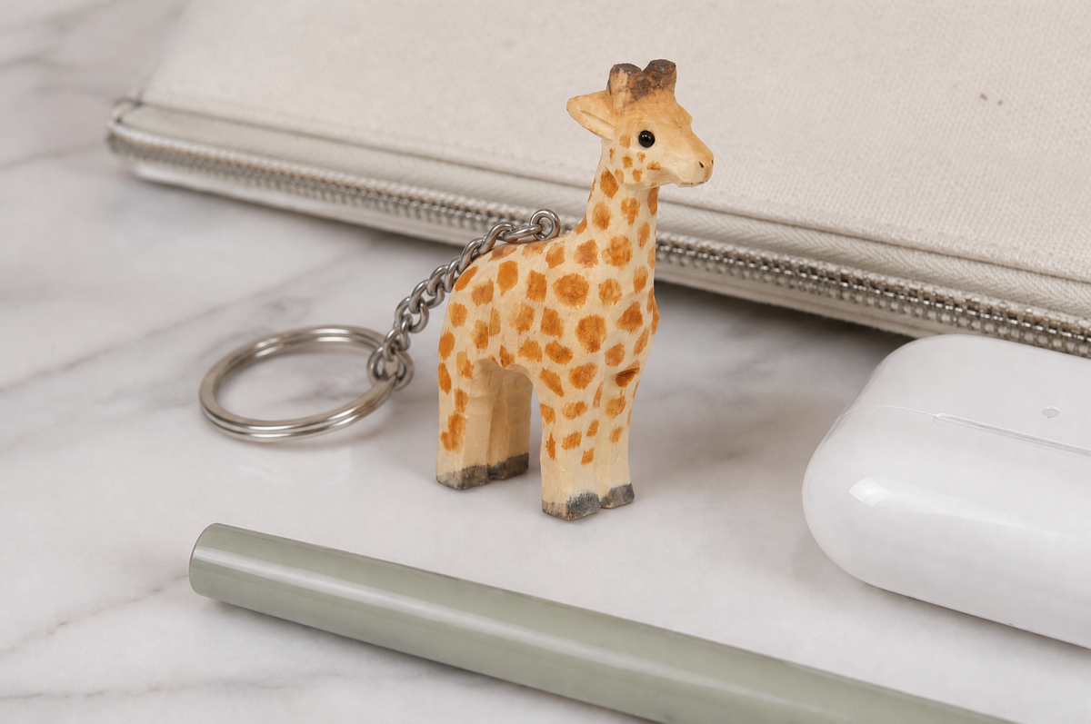 Giraffe hand-carved wooden keychain by Selsela, in a styled scene