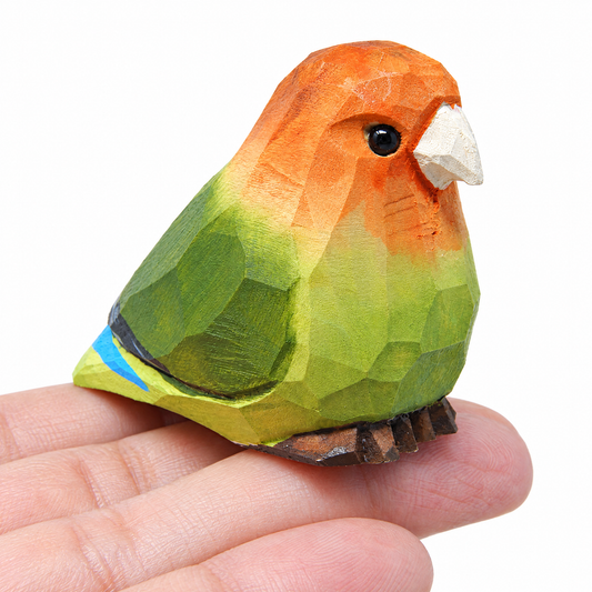Lovebirds hand-carved wooden figurine by Selsela, on a plain background