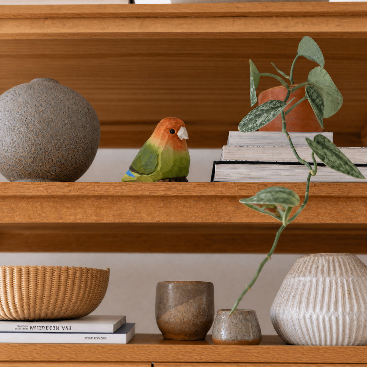 Lovebirds hand-carved wooden figurine by Selsela, styled in a home setting