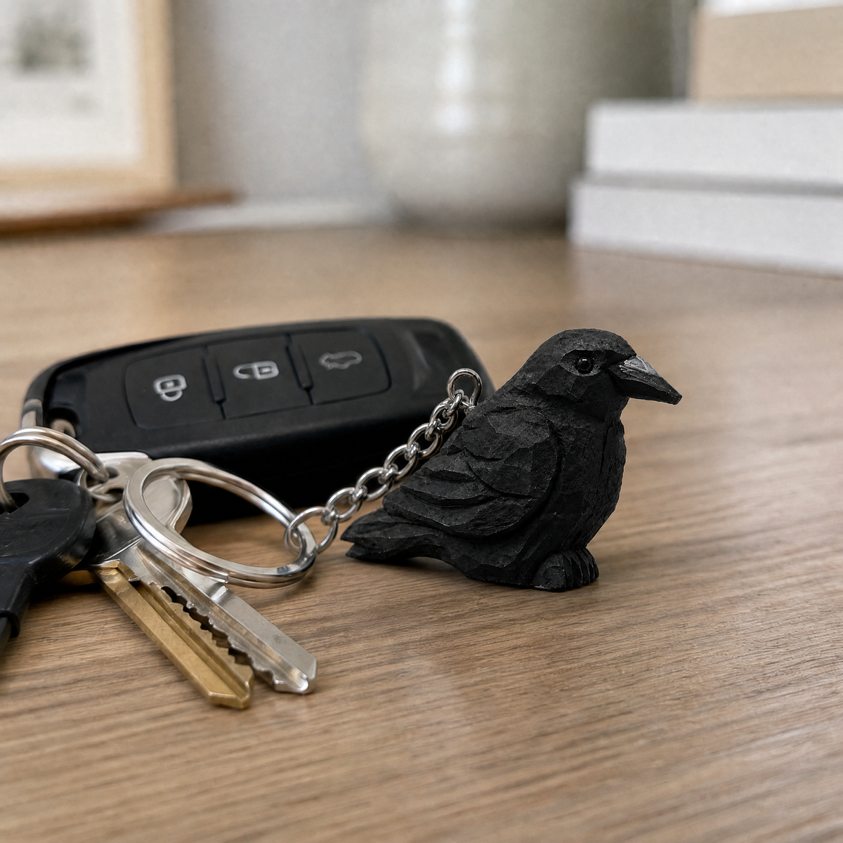 Raven hand-carved wooden keychain by Selsela, in a styled scene