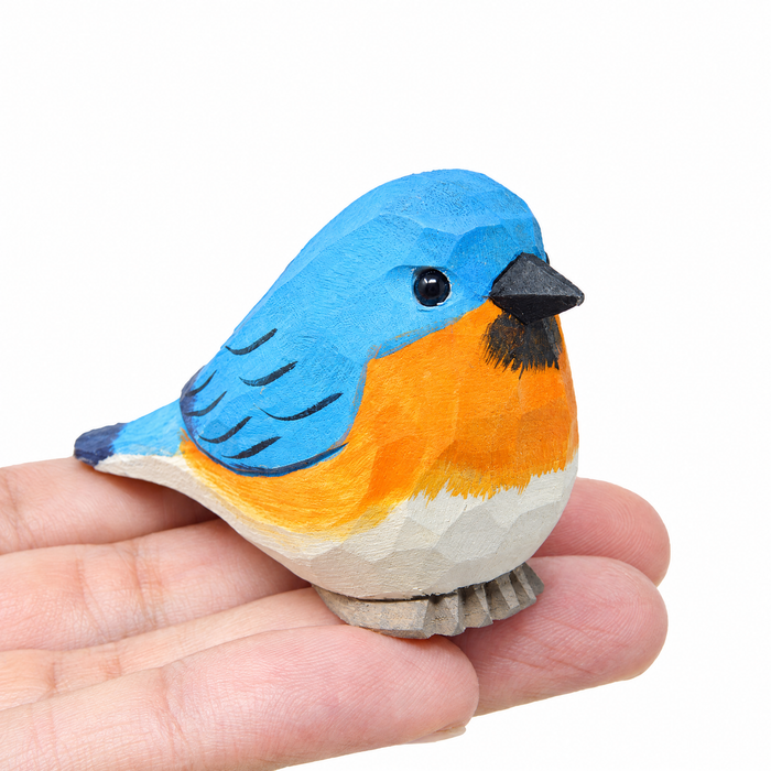 Eastern Bluebird hand-carved wooden figurine by Selsela, on a plain background