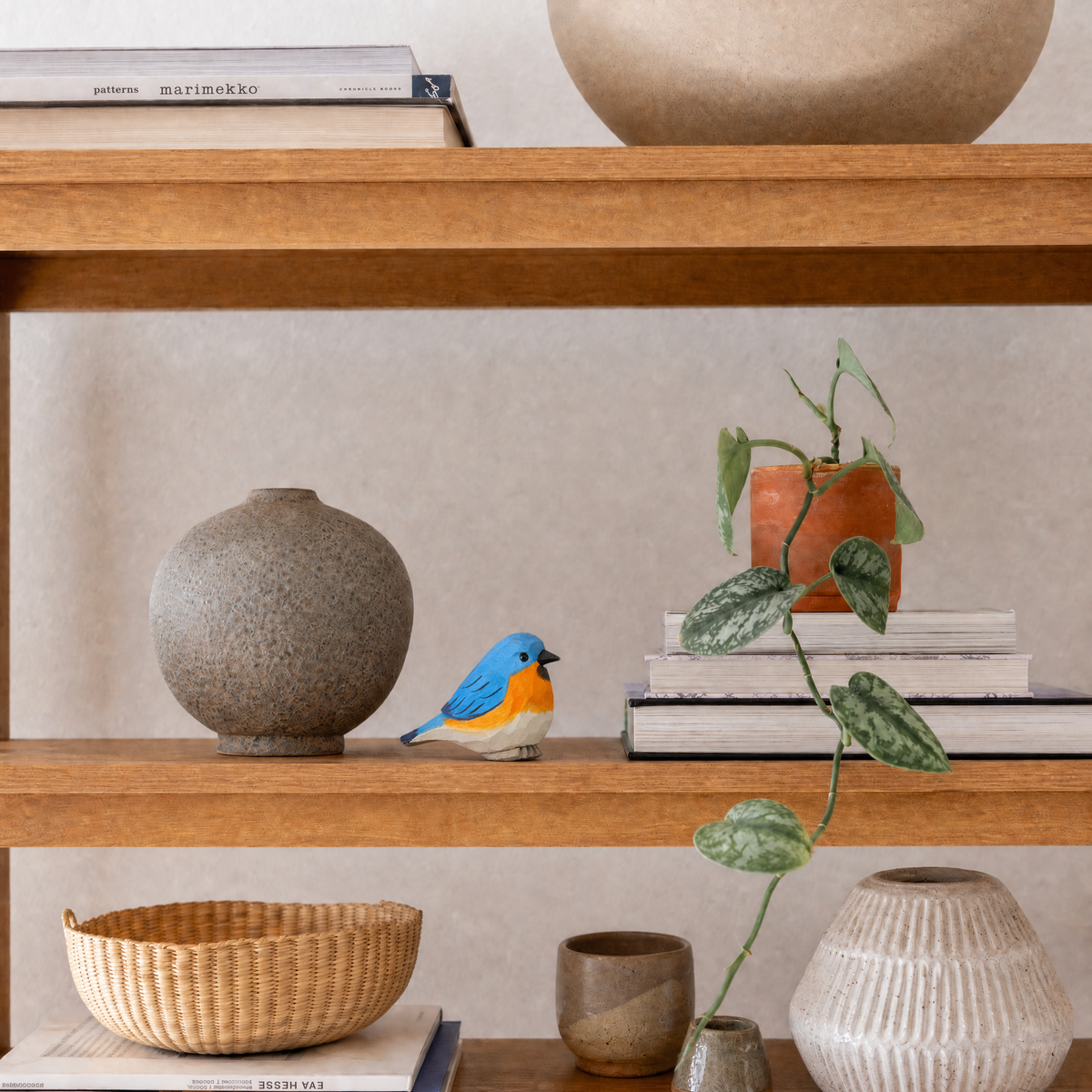 Eastern Bluebird hand-carved wooden figurine by Selsela, styled in a home setting