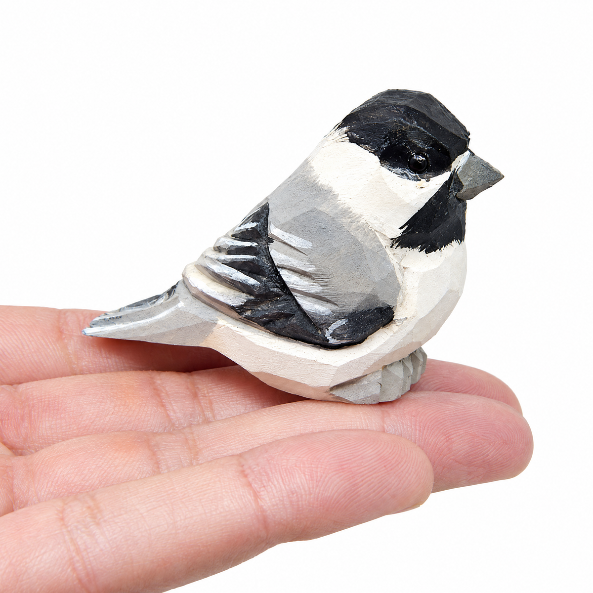 Chickadee hand-carved wooden figurine by Selsela, on a plain background