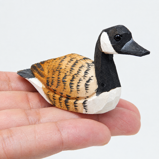 Canada Goose hand-carved wooden figurine by Selsela, on a plain background