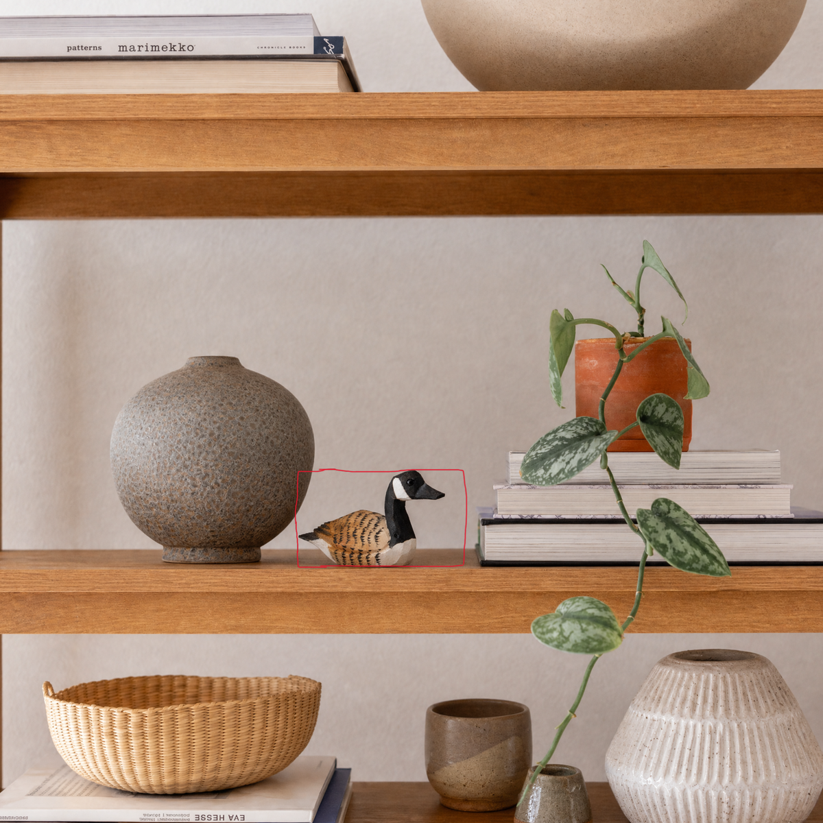 Canada Goose hand-carved wooden figurine by Selsela, styled in a home setting