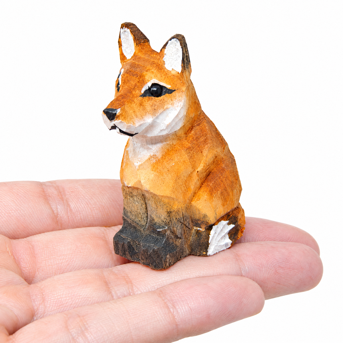 Red Fox hand-carved wooden figurine by Selsela, on a plain background