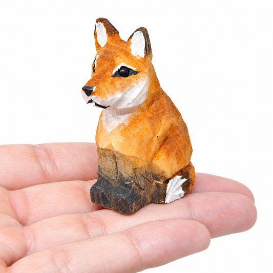 Red Fox hand-carved wooden figurine by Selsela, on a plain background