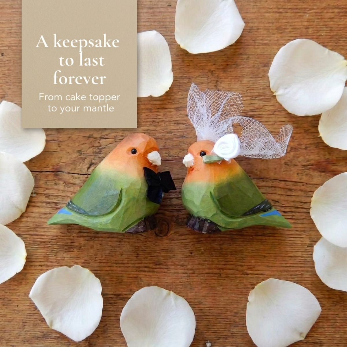 Lovebirds hand-carved wooden cake topper by Selsela, bride and groom pair on a wedding cake