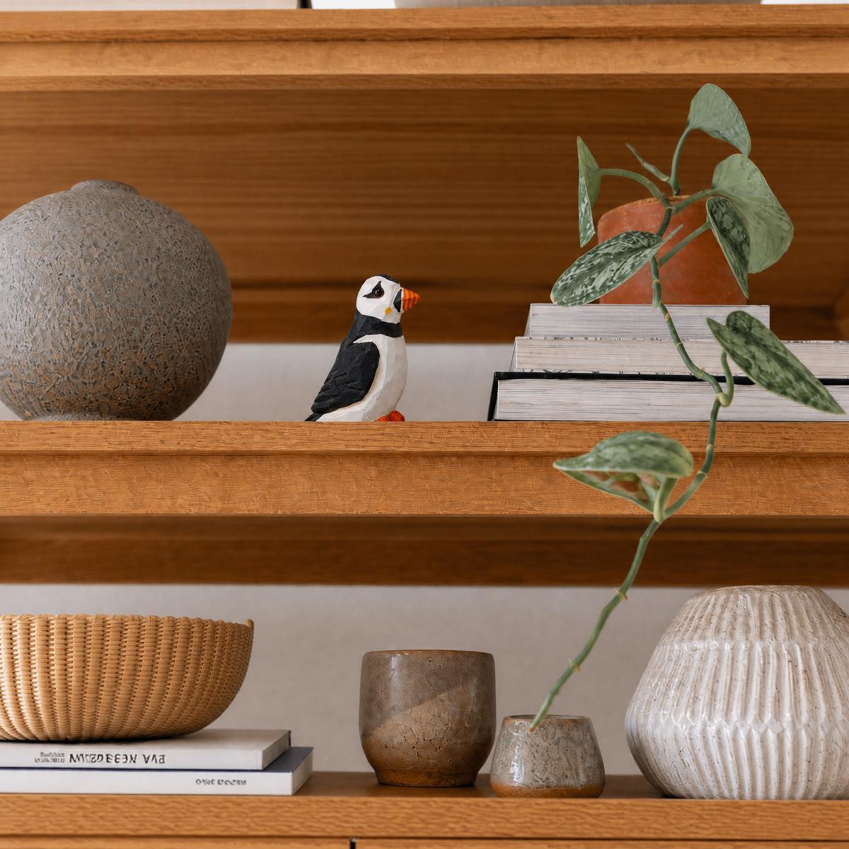 Puffin hand-carved wooden figurine by Selsela, styled in a home setting