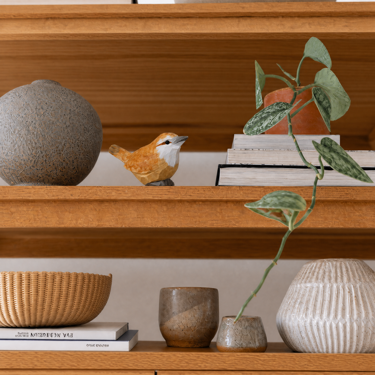 Carolina Wren hand-carved wooden figurine by Selsela, styled in a home setting