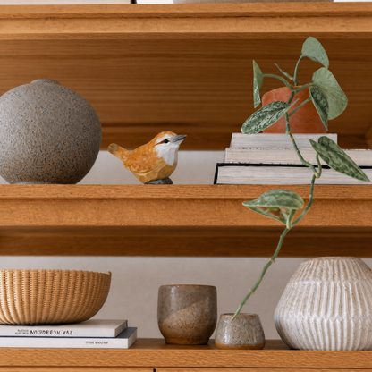 Carolina Wren hand-carved wooden figurine by Selsela, styled in a home setting