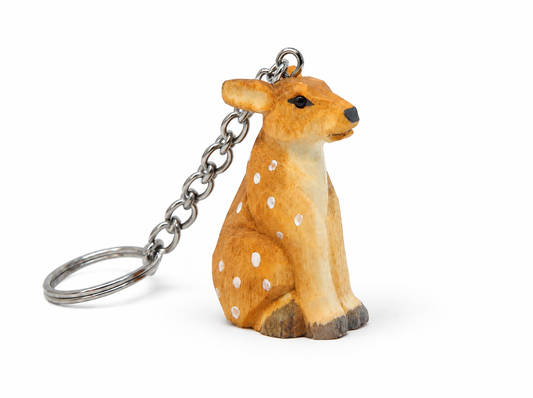 Deer hand-carved wooden keychain by Selsela, on a plain background