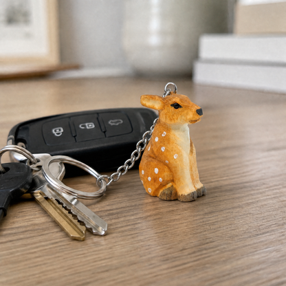 Deer hand-carved wooden keychain by Selsela, in a styled scene