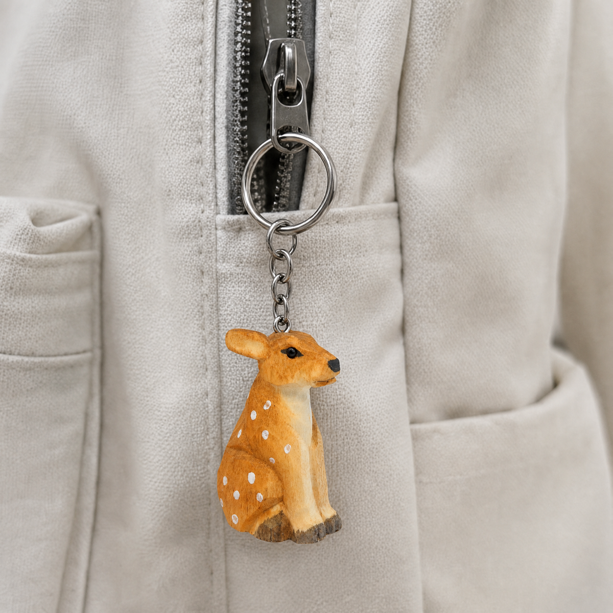 Deer hand-carved wooden keychain by Selsela, in a styled scene