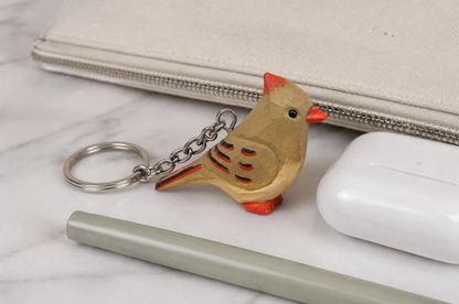Cardinal Female hand-carved wooden keychain by Selsela, in a styled scene
