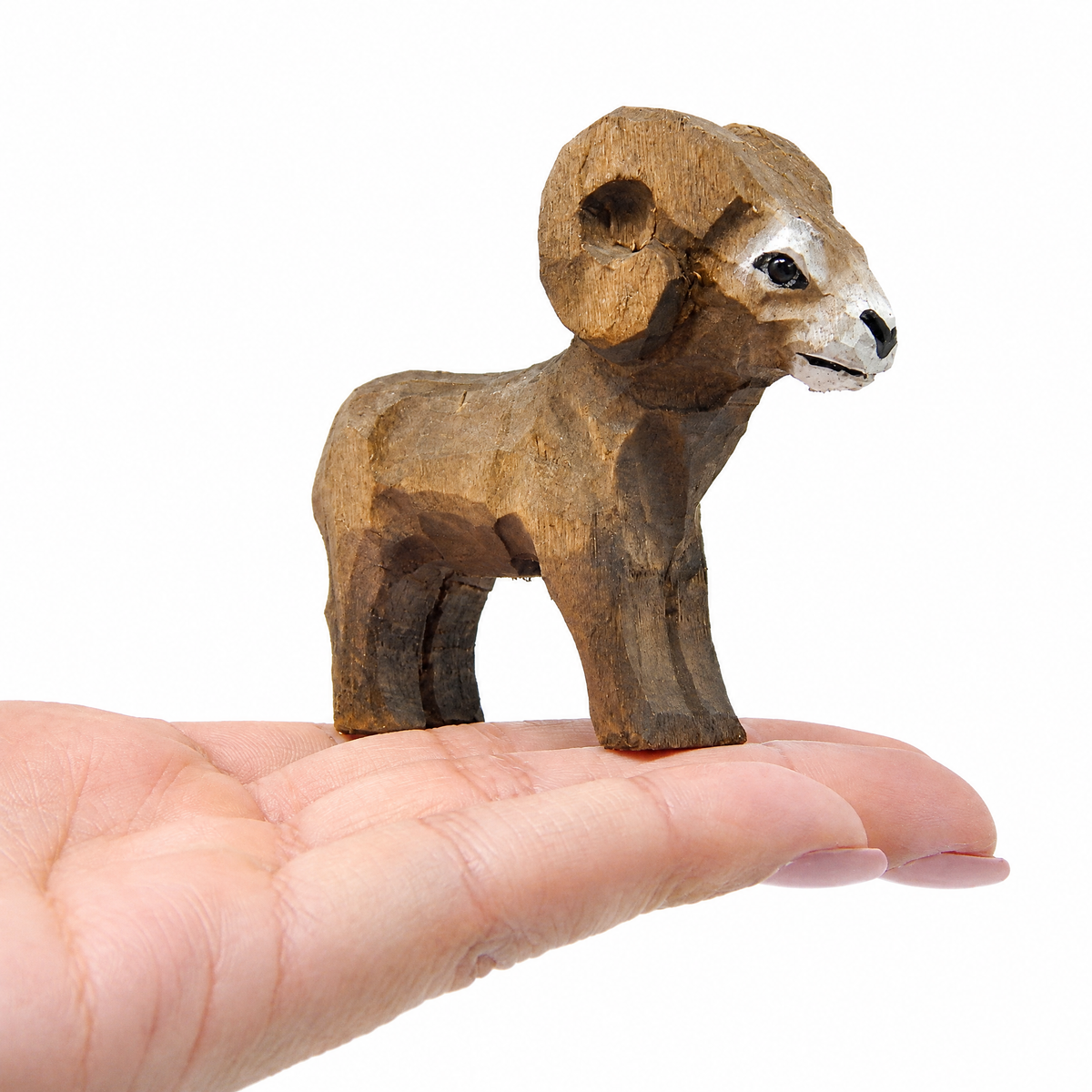 Ram hand-carved wooden figurine by Selsela, on a plain background