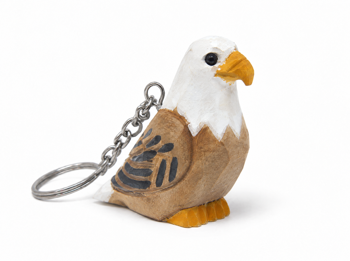 Bald Eagle hand-carved wooden keychain by Selsela, on a plain background