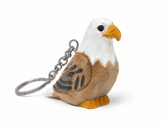 Bald Eagle hand-carved wooden keychain by Selsela, on a plain background