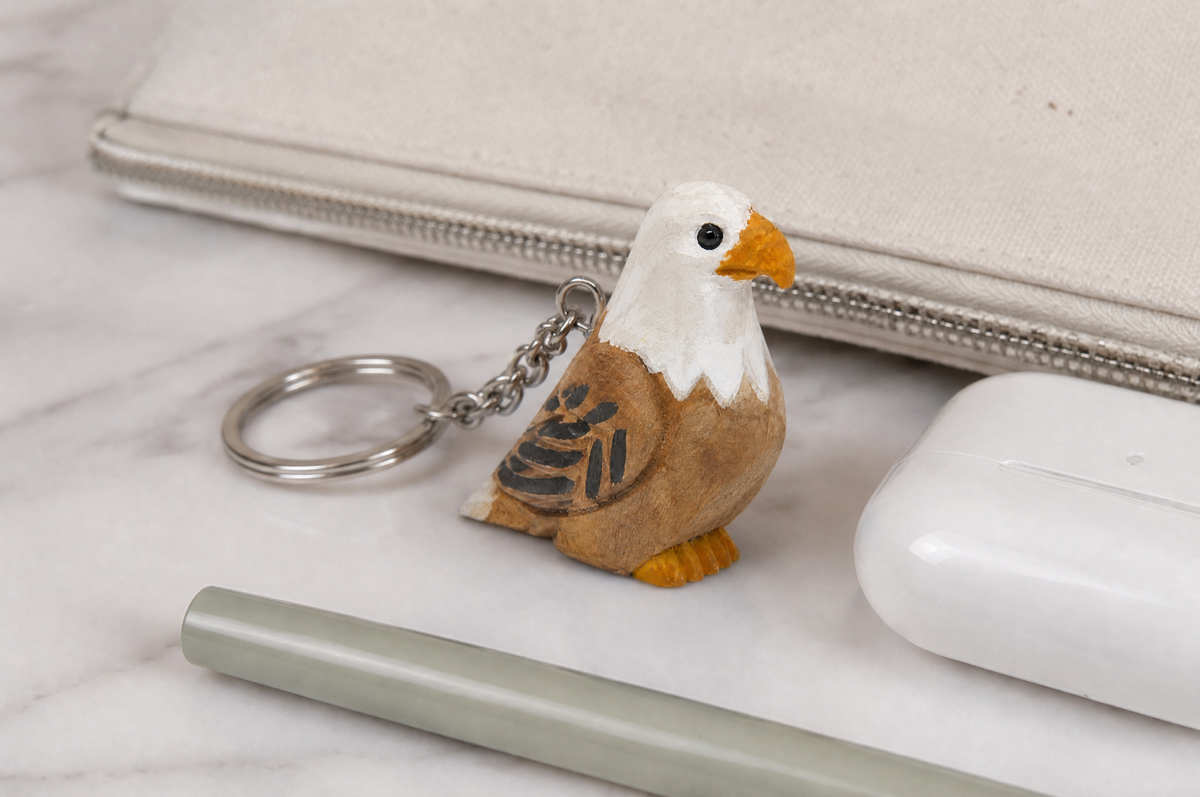 Bald Eagle hand-carved wooden keychain by Selsela, in a styled scene