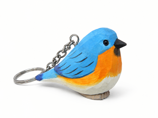 Eastern Bluebird hand-carved wooden keychain by Selsela, on a plain background