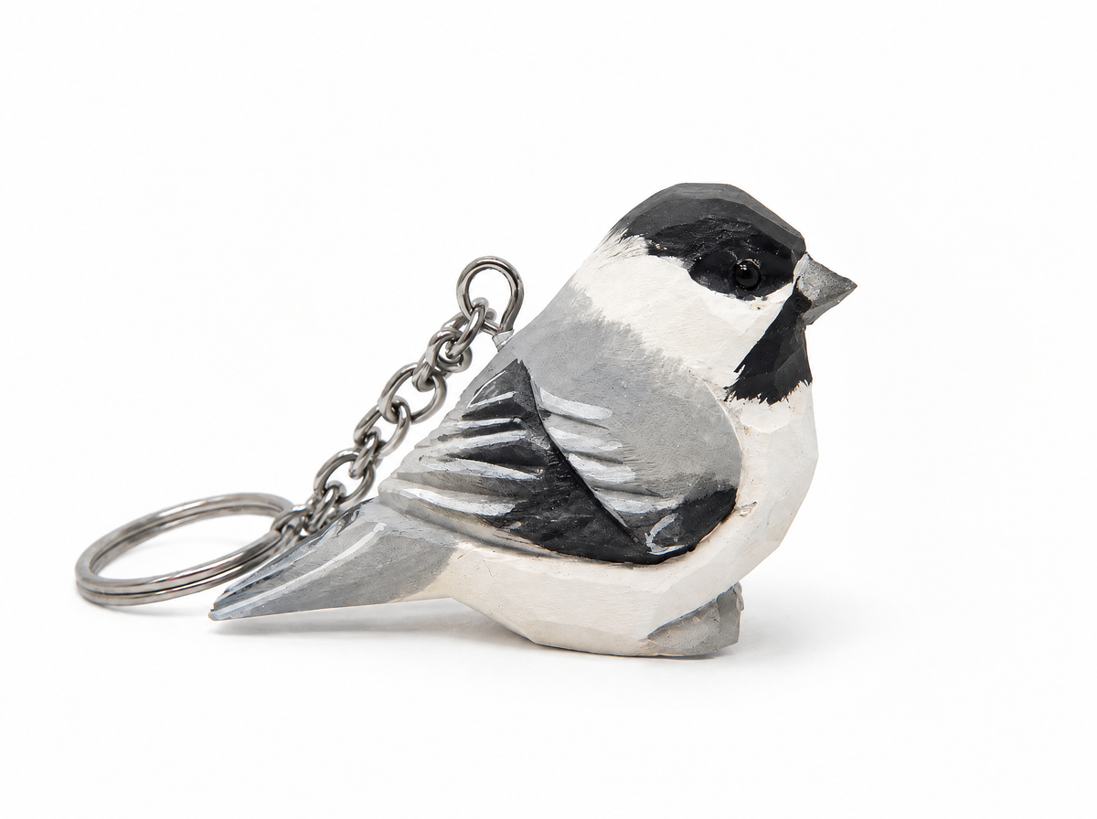 Chickadee hand-carved wooden keychain by Selsela, on a plain background
