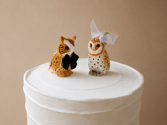 Barn Owl hand-carved wooden cake topper by Selsela, bride and groom pair on a wedding cake