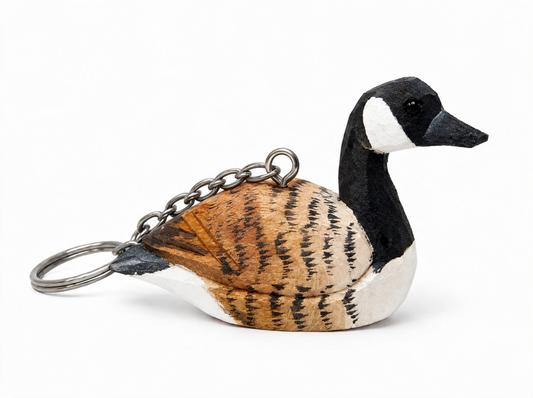Canada Goose hand-carved wooden keychain by Selsela, on a plain background