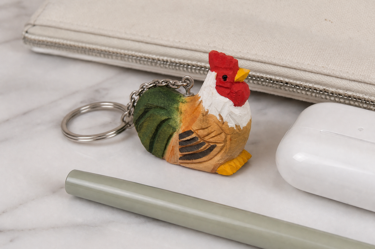 Rooster hand-carved wooden keychain by Selsela, in a styled scene