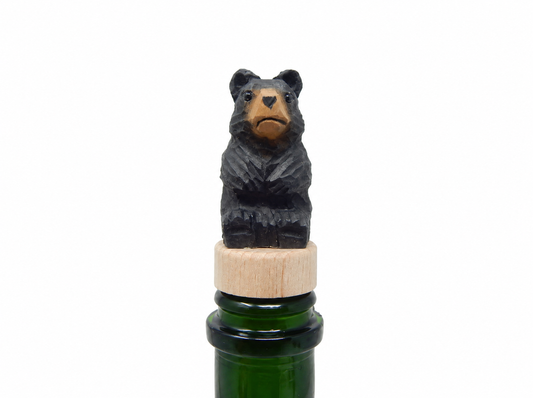 Black Bear hand-carved wooden wine stopper by Selsela, on a plain background