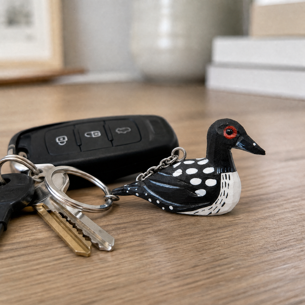 Common Loon hand-carved wooden keychain by Selsela, in a styled scene