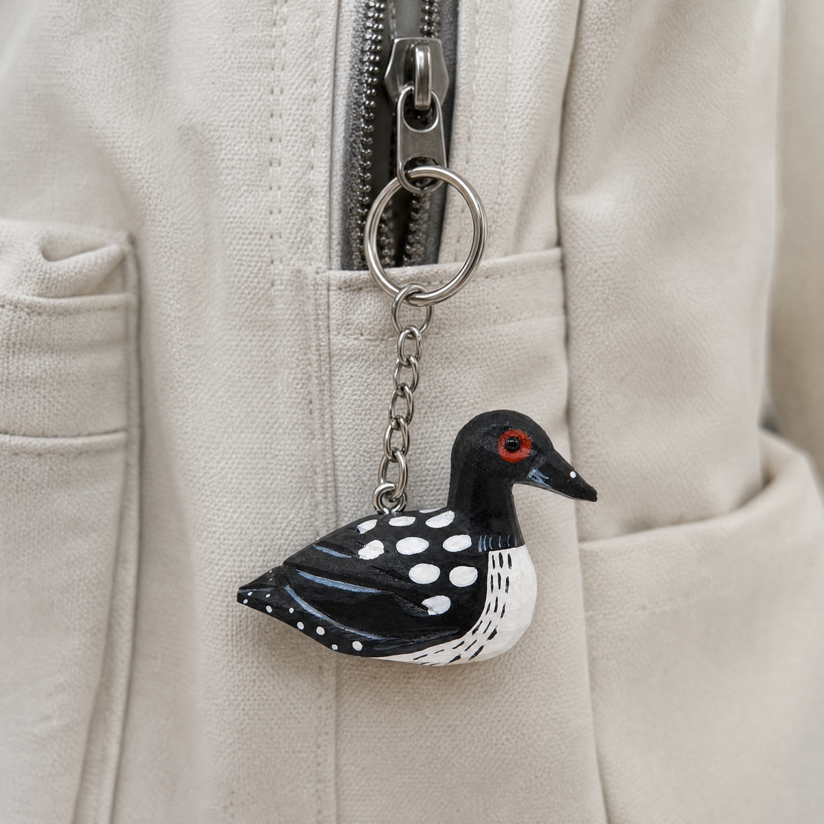 Common Loon hand-carved wooden keychain by Selsela, in a styled scene
