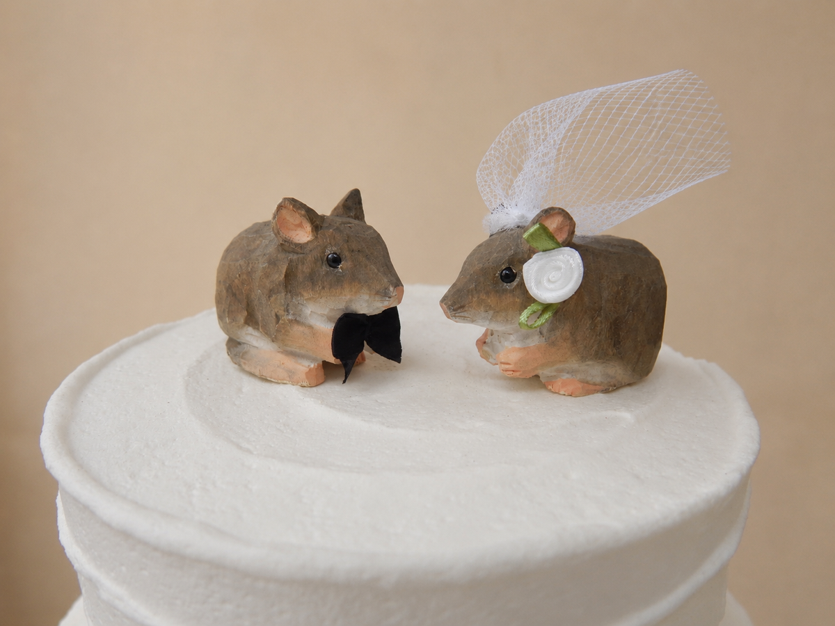 Mouse Gray hand-carved wooden cake topper by Selsela, bride and groom pair on a wedding cake