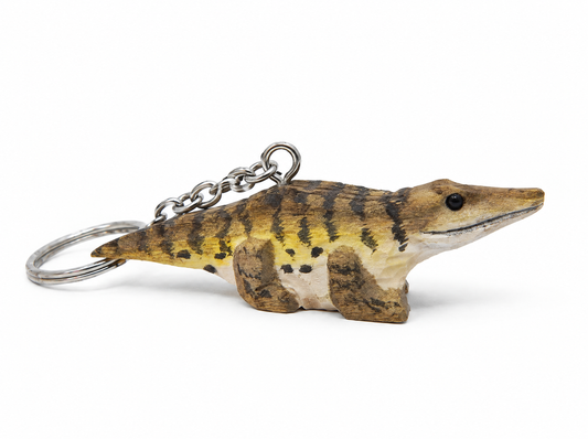 Crocodile hand-carved wooden keychain by Selsela, on a plain background