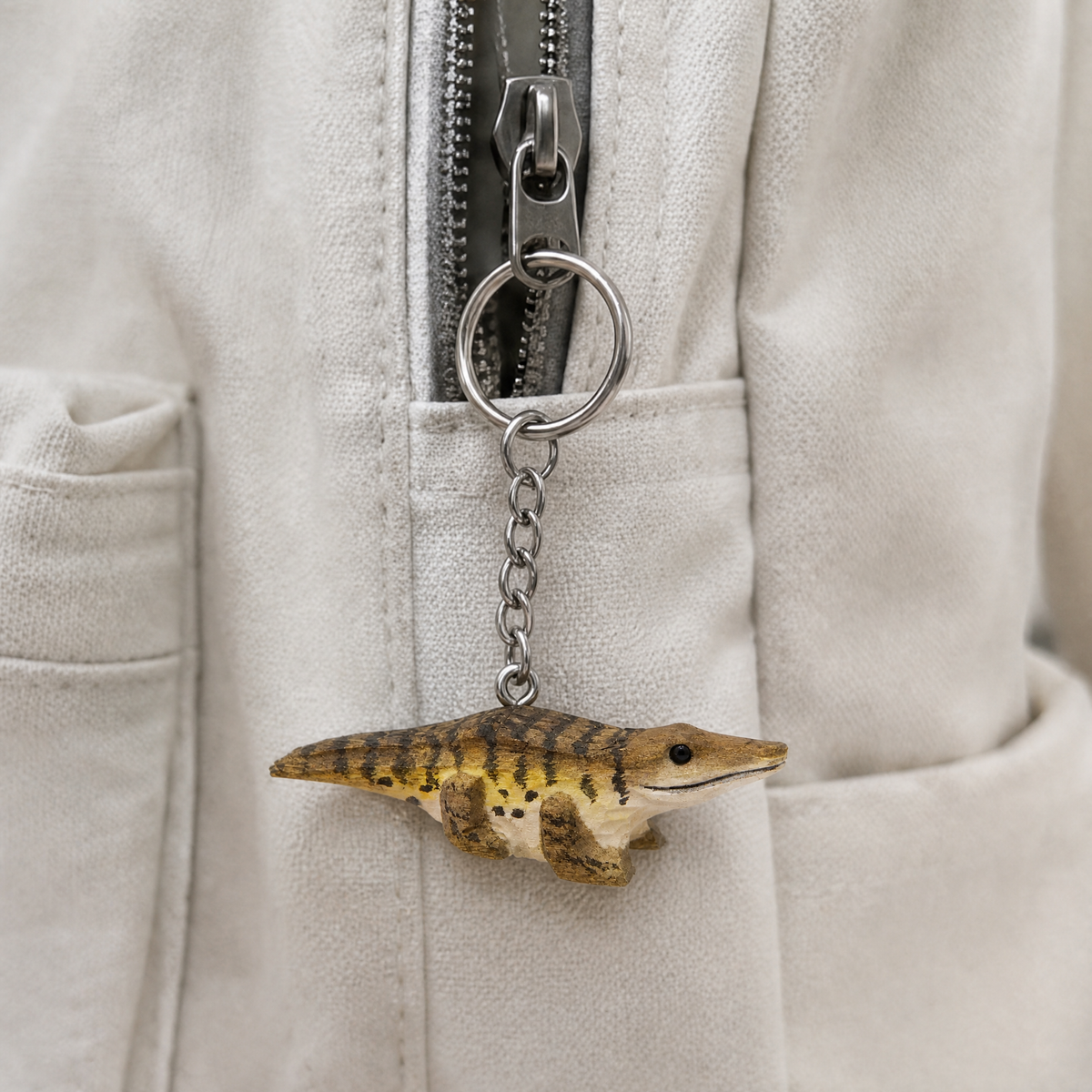 Crocodile hand-carved wooden keychain by Selsela, in a styled scene