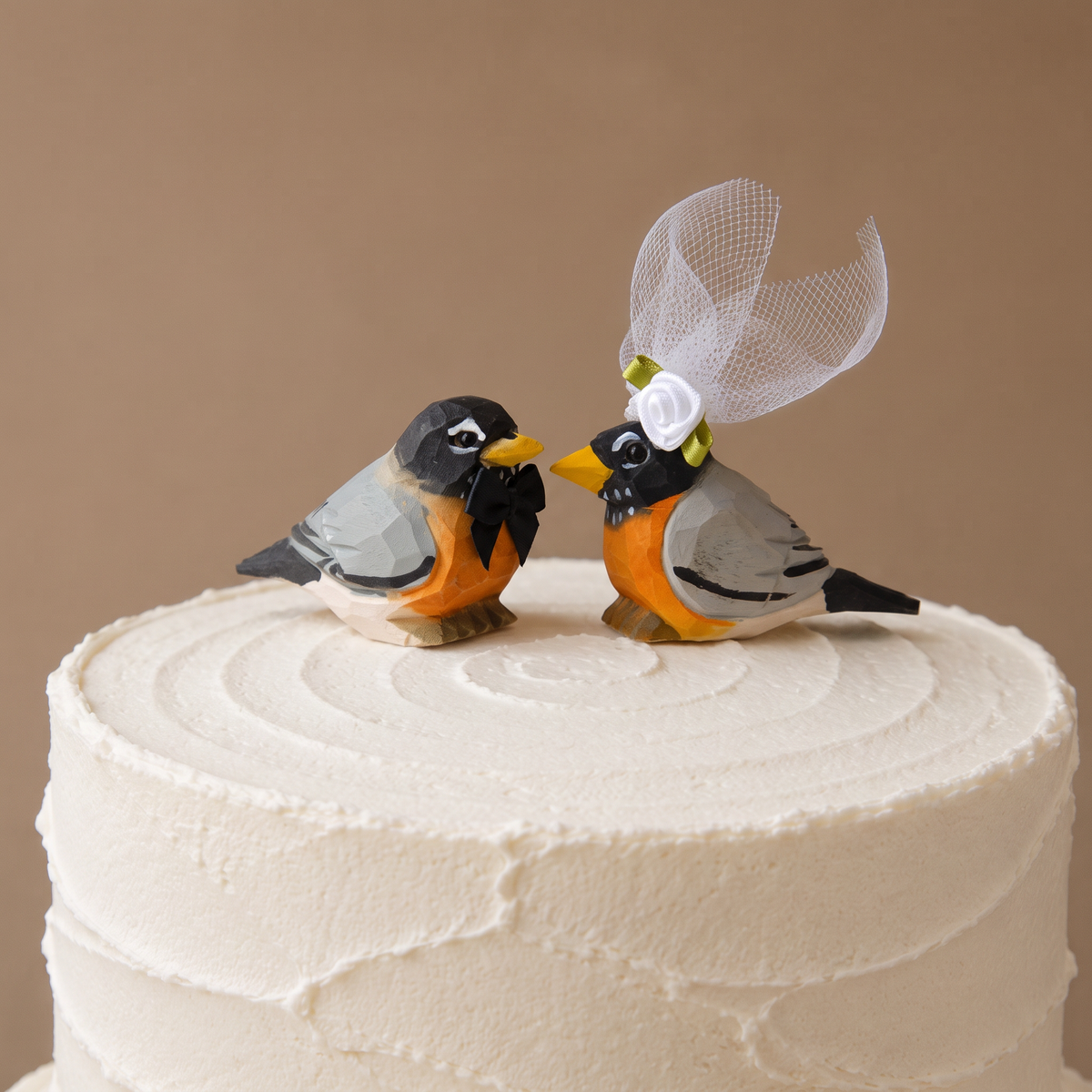 American Robin hand-carved wooden cake topper by Selsela, bride and groom pair on a wedding cake